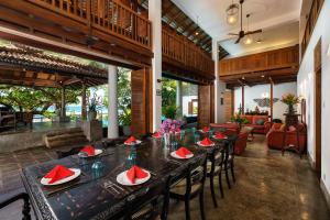 a dining room with a long table and chairs at Royal Indigo Villa in Talpe