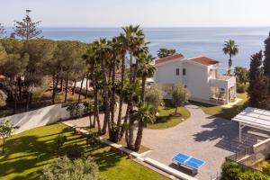 an aerial view of a house with palm trees and the ocean at Caiammari Boutique Hotel & Spa in Syracuse