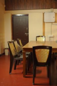 a dining room with a table and chairs at Greene Villa in Palakkad