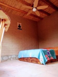Cama en habitación con techo en Amancay Aspha en San Carlos