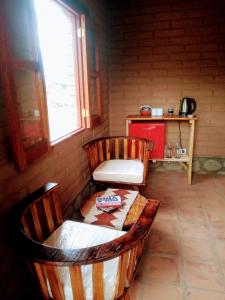 a room with two chairs and a table and a window at Amancay Aspha in San Carlos
