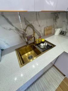 a kitchen counter with a sink in a kitchen at ZenStay Retreats Private Luxury Beach House Rental in Pandan