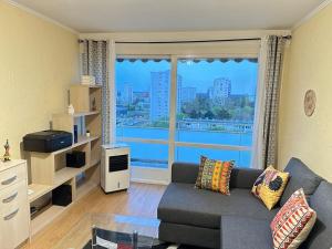 Exotic Spacious Stylish Apartment Retreat في Ris-Orangis: غرفة معيشة مع أريكة ونافذة كبيرة