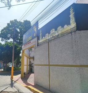 a building with a sign on the side of it at Hotel Dubái in Texcoco de Mora