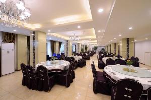 a banquet hall with tables and chairs and a chandelier at Chong Li Hotel Chengdu in Chengdu
