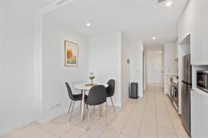 a kitchen and dining room with a table and chairs at Cozy 1 bedroom in the Heart of South Brisbane with parking in Brisbane