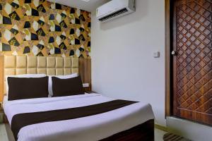 sypialnia z dużym łóżkiem z dużym zagłówkiem w obiekcie OYO Hotel Angel Park w mieście Ahmadabad