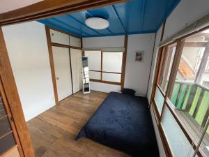 an empty room with a blue ceiling at Blue House in Beppu