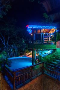 a resort with a swimming pool at night at Hostal El Santuario in Minca
