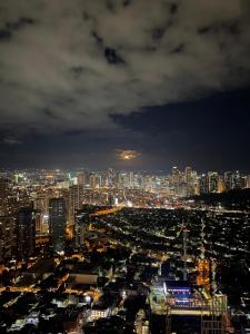 a view of a city at night at The Gramercy Residences by ASG in Manila