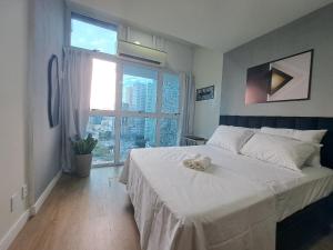 Un dormitorio con una cama con una toalla. en Lindo FLAT47 metrô e VLT da CARIOCA - LAPA, en Río de Janeiro