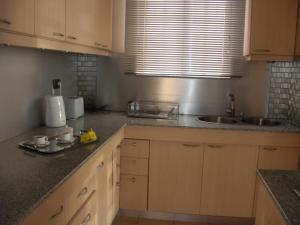 a kitchen with a sink and a counter top at Villa No2 - Sun Tan Palmar in Belle Mare +33 photos