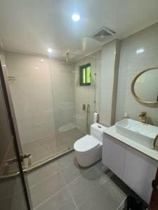 a bathroom with a shower and a toilet and a sink at ZenStay Retreats Private Luxury Beach House Rental in Pandan
