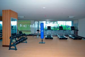 a gym with a large room with treadmills and machines at KingJada Hotels And Apartments Ltd in Dar es Salaam