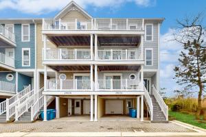 a large apartment building with white balconies at Villas of Beach Cove --- 29076 Beach Cove Square #D7 in Bayberry Dunes