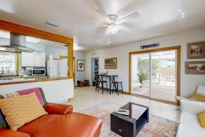a living room with a couch and a kitchen at The Peaceful Ocala Bungalow in Ocala