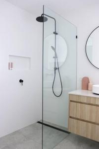 a glass shower in a bathroom with a sink at Beautiful Duplex in Miami - Close to the Beach in Gold Coast