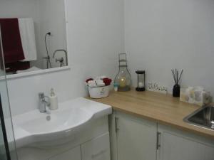 a white kitchen with a sink and a counter at Warriwul Farmland Rural Retreat BnB, Curramore/Jamberoo in Jamberoo