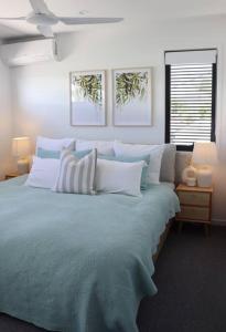 a bedroom with a large blue bed with pillows at Beautiful Duplex in Miami - Close to the Beach in Gold Coast