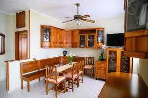 a kitchen with a dining room table and chairs at Relaxing House in Lido di Ostia