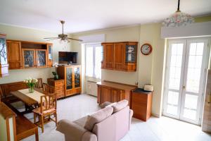 a kitchen and living room with a couch and a table at Relaxing House in Lido di Ostia