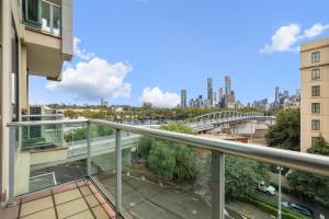 a balcony with a view of the city at East Melbourne 2BR Apartment in Melbourne