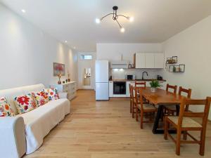 a living room and kitchen with a couch and a table at Tuscany Hills La Veduta in Certaldo