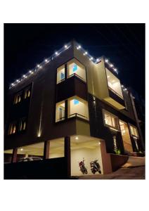 a building with lights on top of it at night at R Hotels By Suraj Residency Yercaud in Yercaud