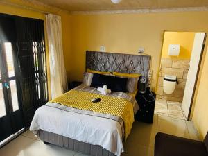 a bedroom with a large bed in a room at Eliza Guest House in Empangeni