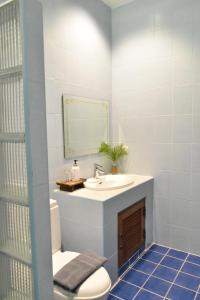 a bathroom with a sink and a toilet and a mirror at Wichouda Homestay in Chiang Dao +26 photos