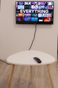 a surfboard sitting on a table in front of a tv at Cozy Studio Apartment in Arad City Center in Arad