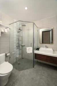 a bathroom with a toilet and a sink and a shower at Harry Phu Quoc Hotel in Phú Quốc +67 photos