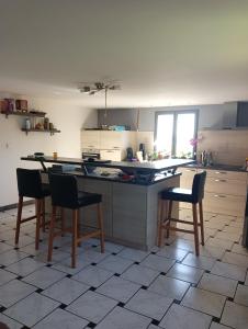 a kitchen with a table and chairs in it at Chez Nath in Aubréville