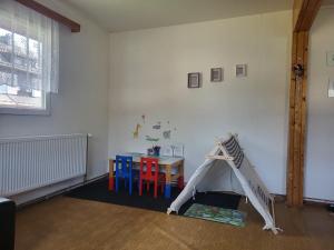 a room with a table and a play tent at Apartmány chata Samoty in Železná Ruda