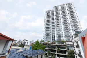 a tall white apartment building in a city at COSY HOUSE - CENTER'S TAY HO - CLOSE THE LAKE in Hanoi