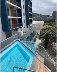 a swimming pool on the side of a building at Modern Retreat in District Six in Cape Town