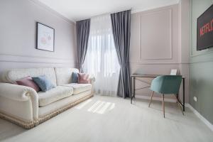 sala de estar con sofá, mesa y ventana en Moonlight Central Apartments, en Oradea