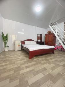a bedroom with a bed and a staircase in it at TRUNG LUONG HOMESTAY in Trung An