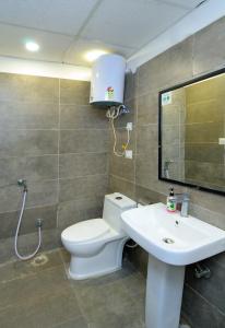 a bathroom with a toilet and a sink at Hotel Red York By Byob Hotels in Noida