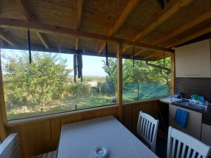 a table and chairs in a room with a window at Къща Виктория in Banya