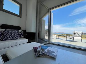 a living room with a couch and a large window at Villa Serene Milos in Empourios