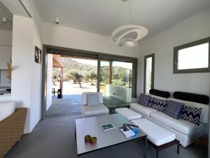 a living room with a couch and a table at Villa Serene Milos in Empourios
