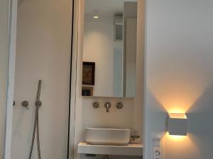 a bathroom with a sink and a mirror at Villa Serene Milos in Empourios