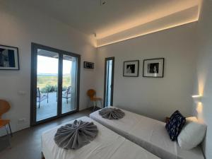 a bedroom with a bed with two pillows on it at Villa Serene Milos in Empourios