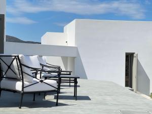 a group of chairs sitting on top of a roof at Villa Serene Milos in Empourios