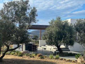 a building with trees in front of it at Villa Serene Milos in Empourios