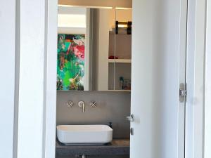 a bathroom with a sink and a mirror at Villa Serene Milos in Empourios