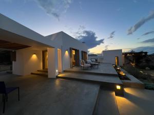 a villa with a view of the ocean at sunset at Villa Serene Milos in Empourios