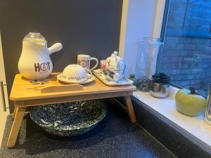 uma mesa com um bule de chá e outros itens sobre ele em Spencer bridge Rooms by AFL em Northampton