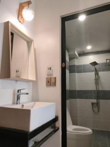 a bathroom with a sink and a toilet and a shower at ENJOY HOME in Da Nang